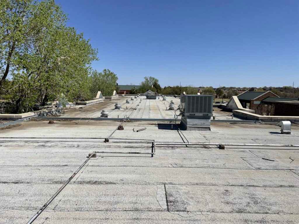 Aging Modified Bitumen flat roof and rooftop units documented during a commercial roof inspection at an assisted living property in Abilene, Texas