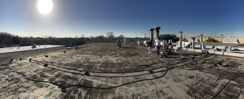 Existing Modified Bitumen roof before restoration at 2606 Freewood Dr, Highland Industrial Park, Dallas