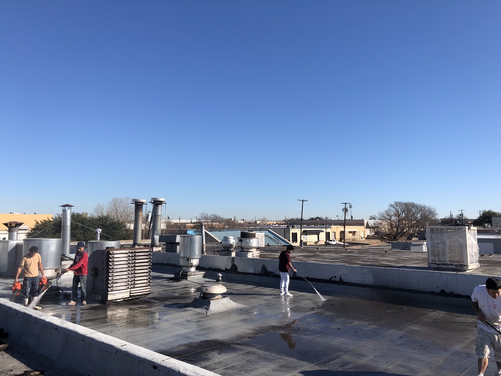 Roof cleaned and trash and old mechanical equipment removed before coating, Dallas, Texas