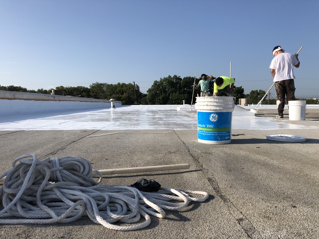 Power washing the commercial roofing system in the Highland Industrial Park, Dallas, Texas