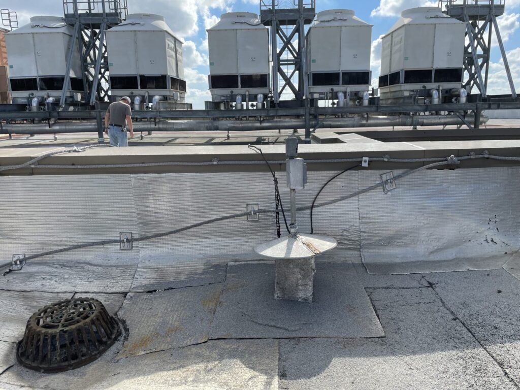 Rusted out pitch pan identified as a point of water intrusion on the Dallas commercial roof