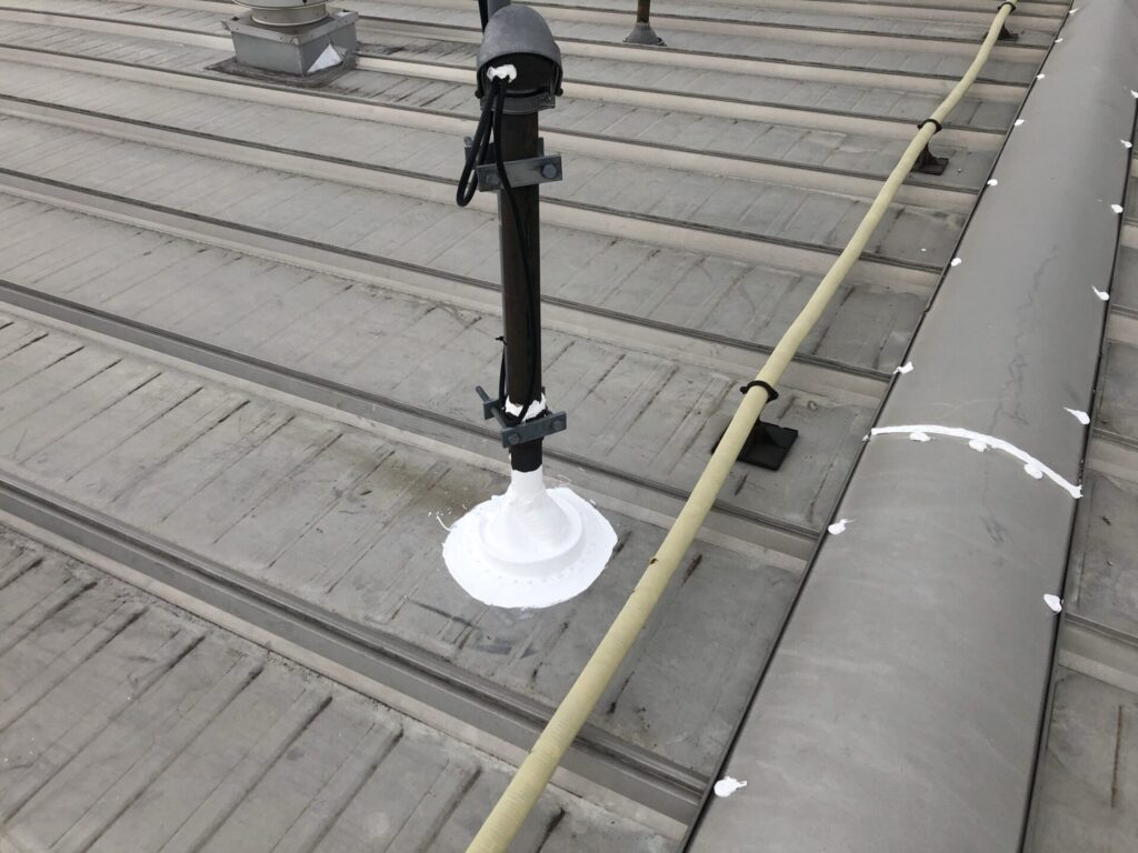 Large box roof vent repaired with silicone coating on the standing seam hangar roof in Dallas