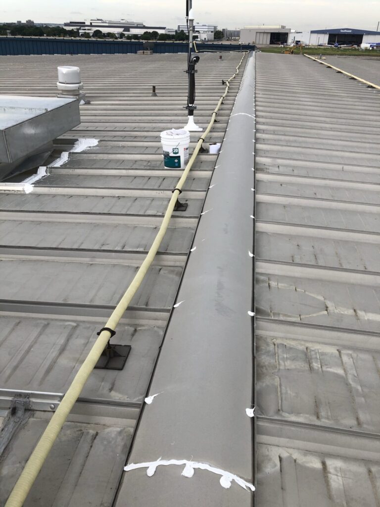 Completed silicone roof repair at the AT&T flight operations hangar near Bachman Lake Park, Dallas