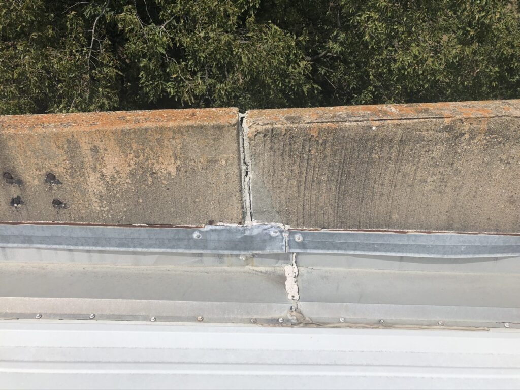 Industrial metal R-panel roof and internal gutter restoration at TSS Drilling on Brass Way, Dallas, TX