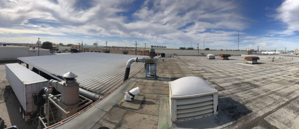 Power washing and debris removal on the commercial roof at GoodYear Tire, Dallas, TX