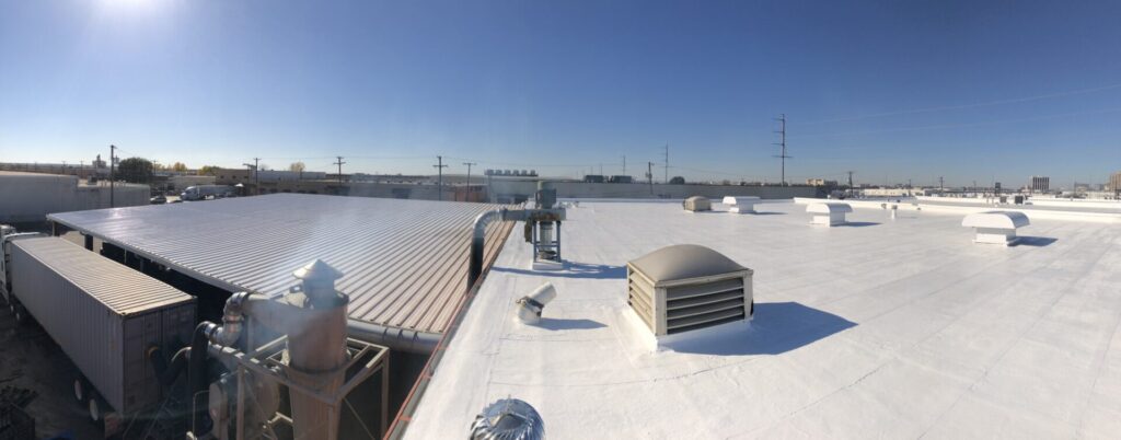 Completed white silicone roof coating at GoodYear Tire retread facility in the Brookhollow industrial area, Dallas