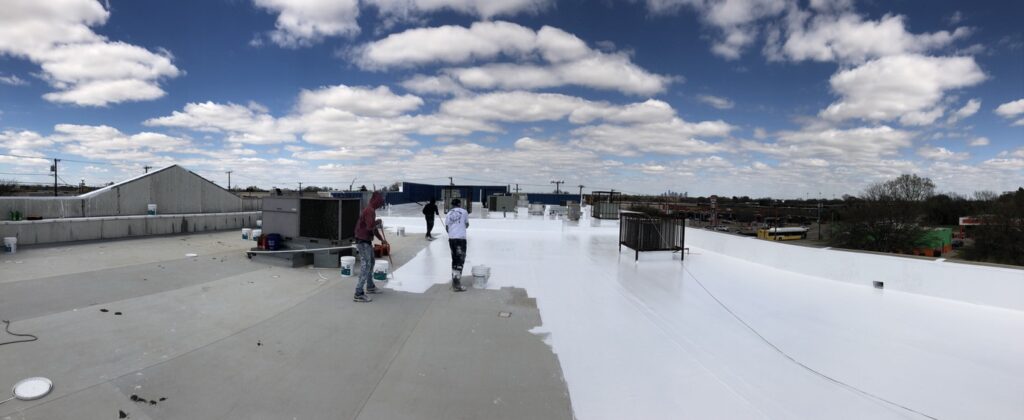 Sealed field seams and penetrations on the Dallas retail center flat roof before silicone top coat