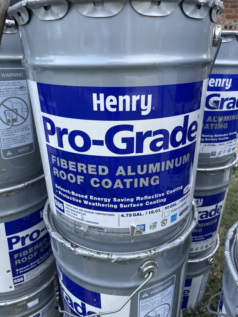 Henry roof coating materials staged on site for the Monarch St multifamily restoration in Dallas