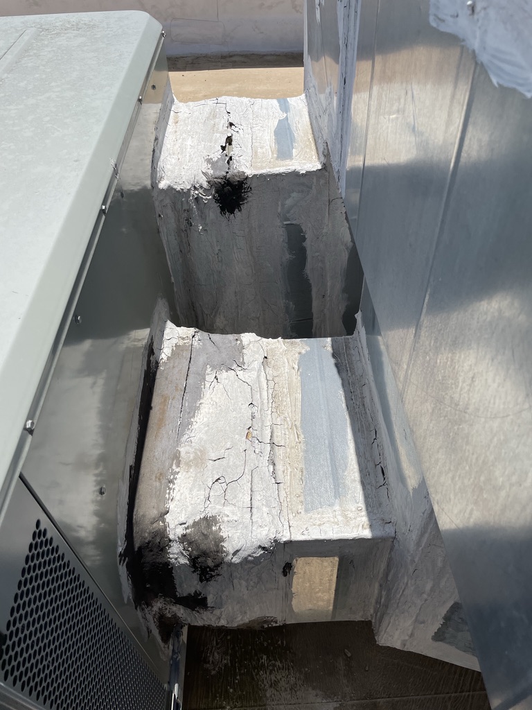 Failed water-based mastic breaking down under UV on a mechanical supply plenum at T-Bank, Dallas, TX