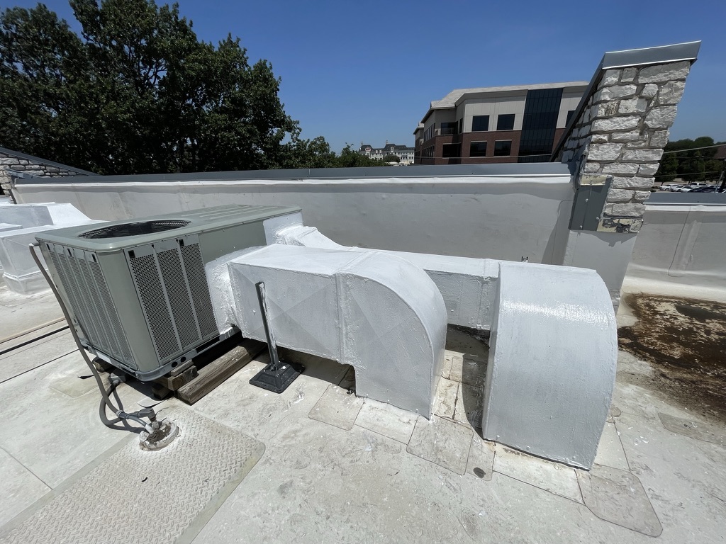 Silicone roof coating applied over a supply plenum, leaving a bright white energy-efficient surface, Dallas