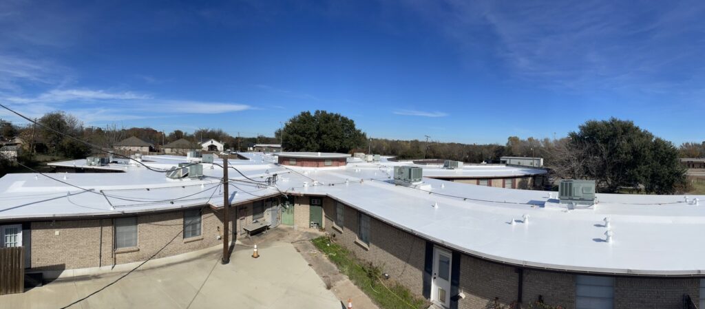 White silicone roof coating applied over the existing commercial TPO roof at Evangelistic Messengers, Ennis