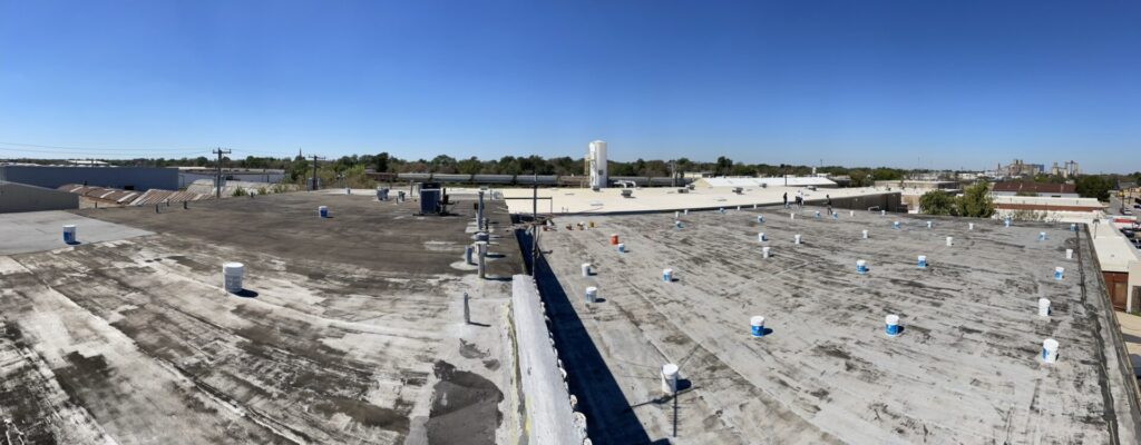 White silicone roof coating over the Modified Bitumen flat roof at Sparkles Home on Bryan Ave., South Fort Worth, TX