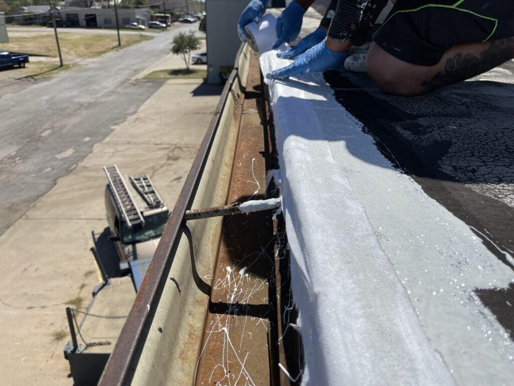 Silicone mastic applied at penetrations and termination bars on the 14,300 sq ft commercial flat roof, Fort Worth