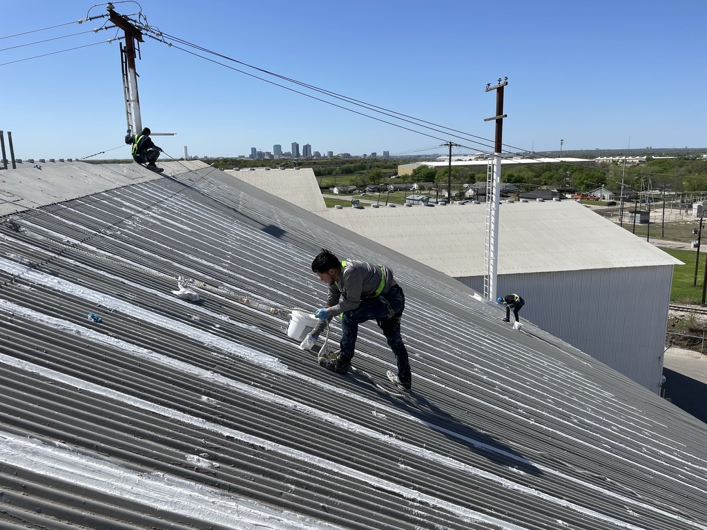 Silicone mastic sealing of joints and penetrations on the steep 8:12 pitch industrial metal roof, Fort Worth