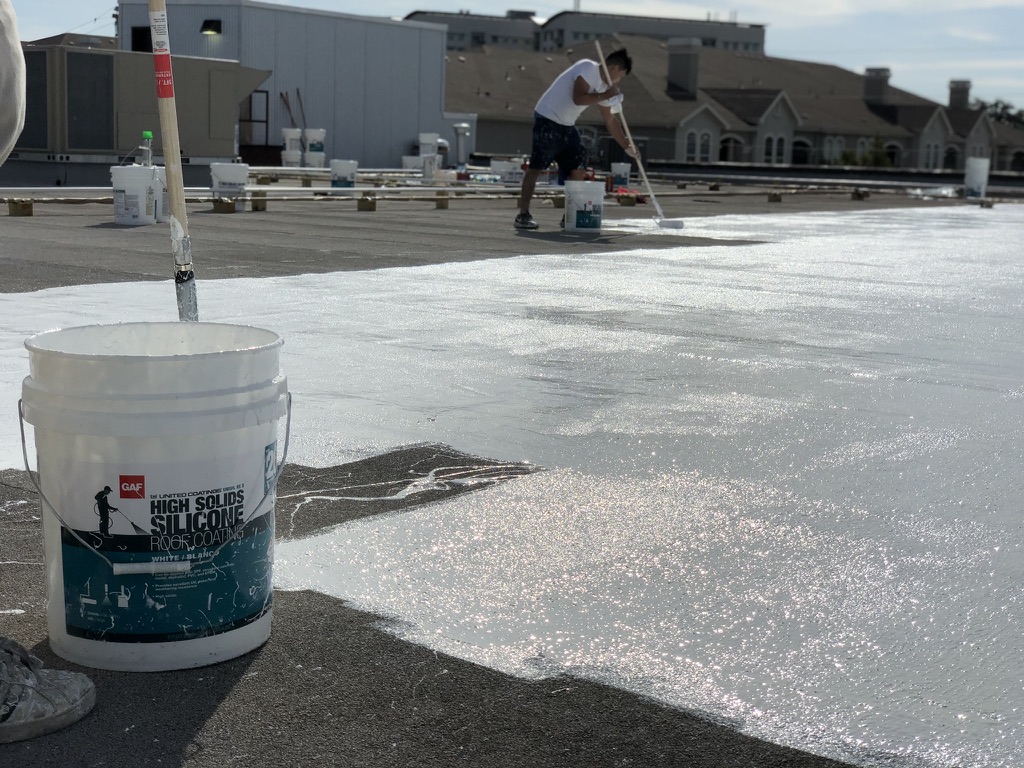 Roof penetrations and terminations sealed with silicone mastic on the commercial roof near the Trinity River, Fort Worth