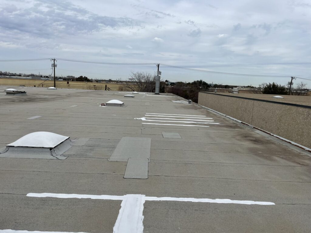 Commercial Modified Bitumen roof repair with silicone coating at 901 Ave. M, Grand Prairie, TX