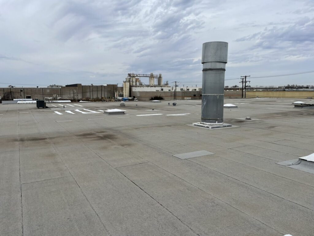 Silicone roof coating applied to commercial flat roof in the Great Southwest Industrial District, Grand Prairie