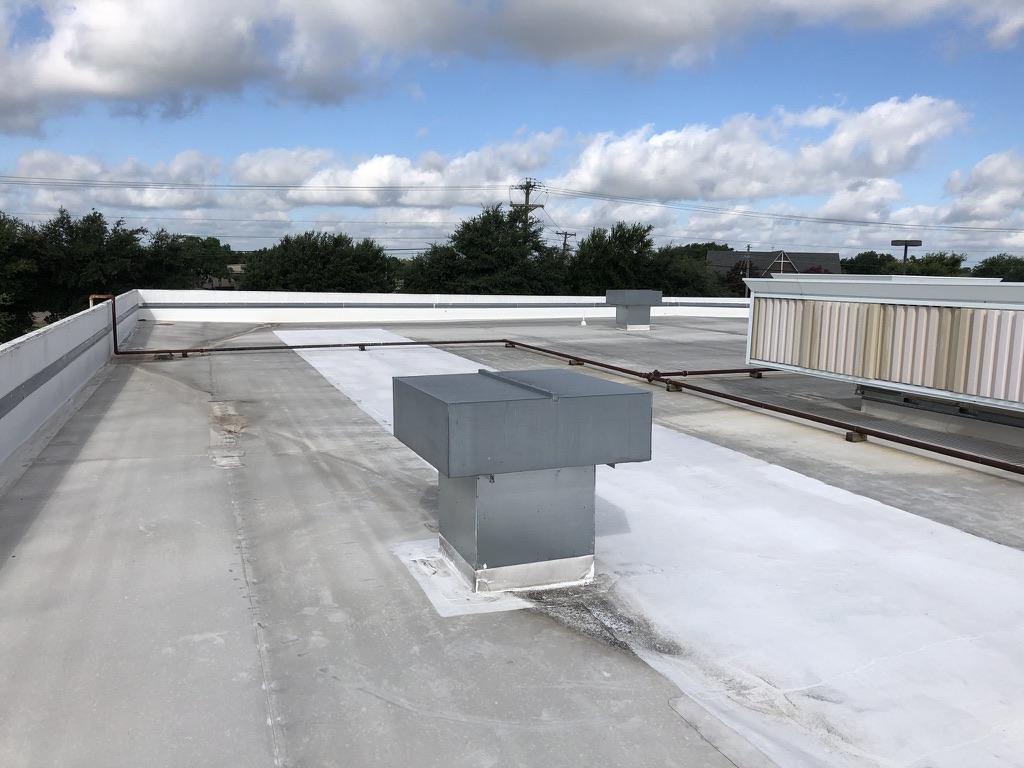 Silicone flood coat over TPO repairs at 8325 Jack Finney Blvd. near Greenville Municipal Airport, TX