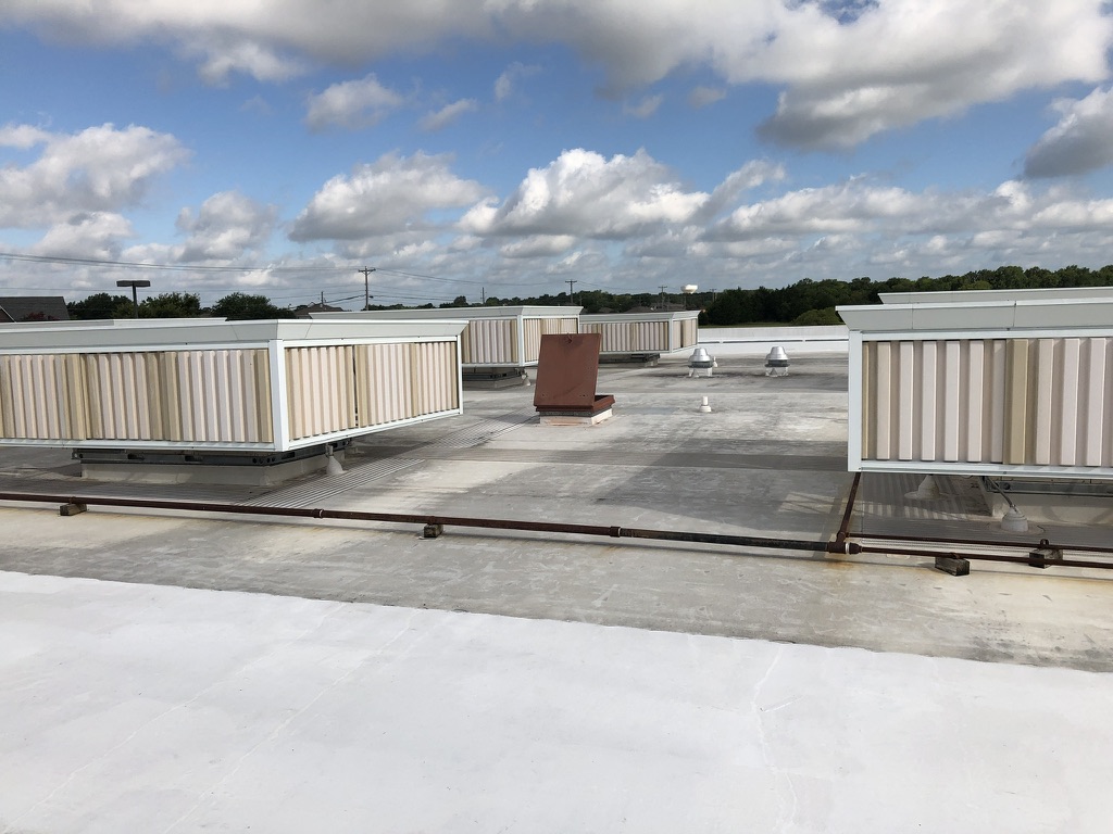 Completed flood coat silicone roof coating over TPO at 8325 Jack Finney Blvd., Greenville, TX