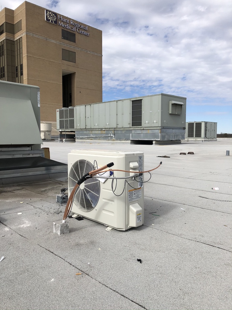 Commercial roofing pitch pan installed over HVAC lines at Hunt Regional Medical Center, Greenville, TX