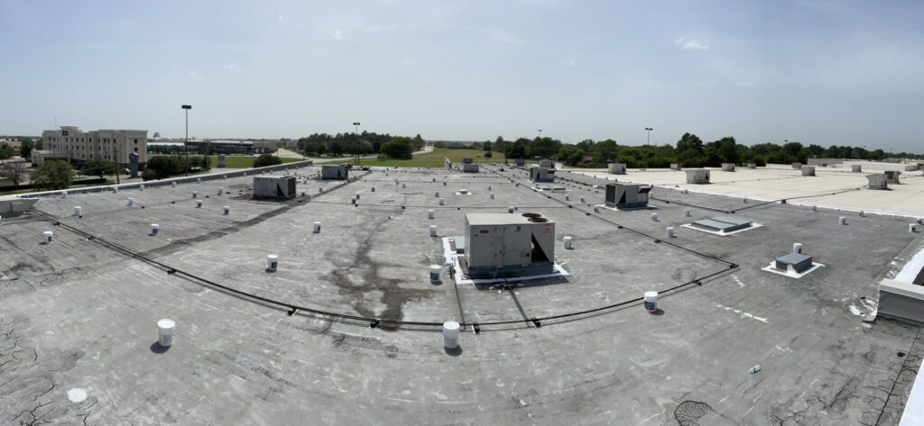 30,000 sq ft commercial flat roof restoration in progress at Greenville Promenade near I-30