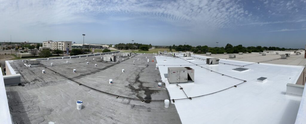 White silicone roof coating over the existing Mod-Bit flat roofing system at Greenville Promenade