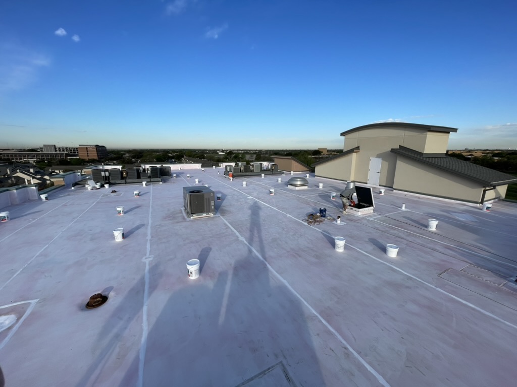 Silicone roof coating application on the upper deck at Saint Camillus Medical Center in Hurst, Texas