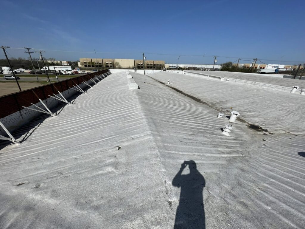 43,000 sq ft SPF roof on I-35E in Lancaster, TX receiving a new acrylic roof coating from Pepper Coatings