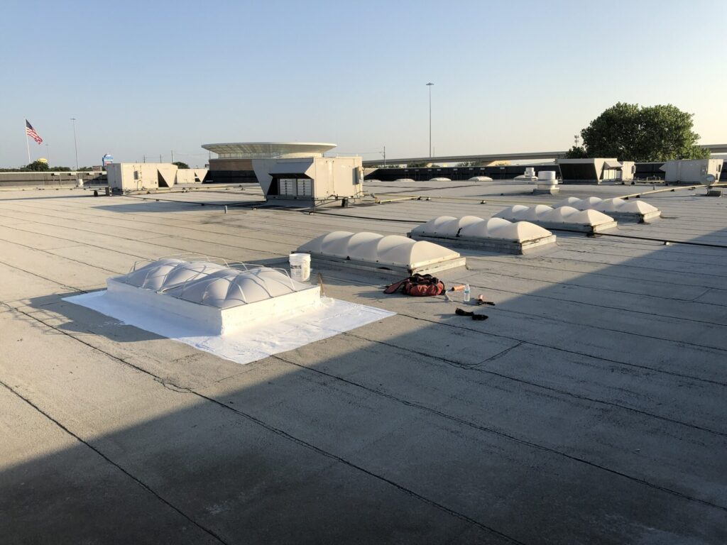 Skylight frame and dome inspected during commercial roof leak detection in Lewisville, Texas
