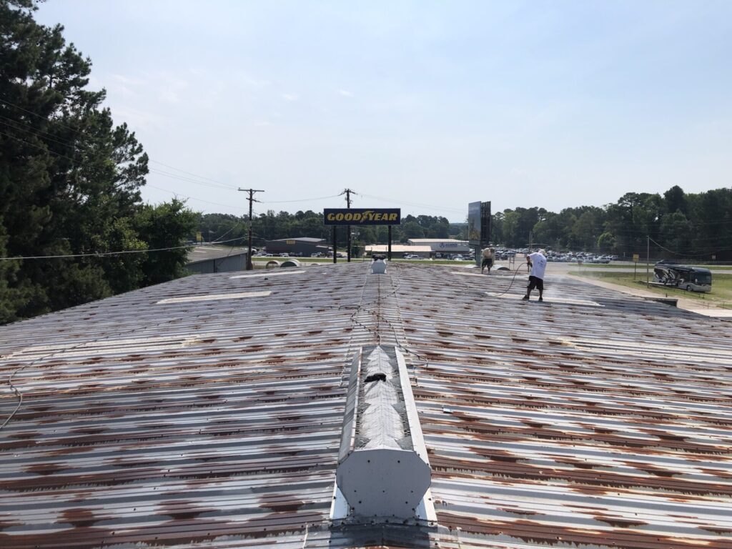 Rusted metal R-panel roof at GoodYear Tire before silicone roof coating, Longview, TX