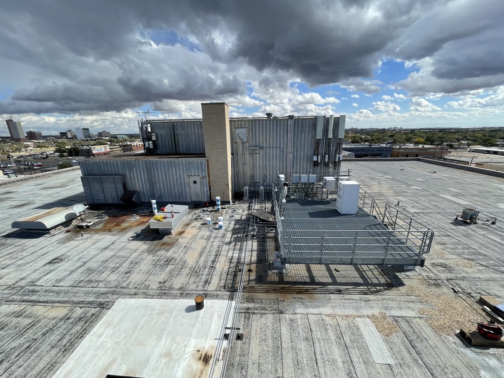 Power washing and debris removal on the commercial roof at the Devon Self Storage property in Lubbock