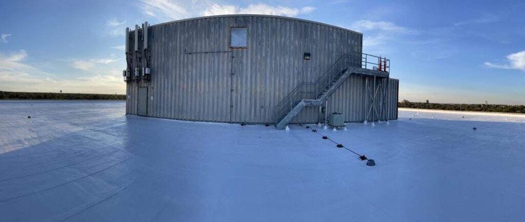Silicone mastic applied at roof drains, penetrations, and perimeter gravel guard in Lubbock, Texas