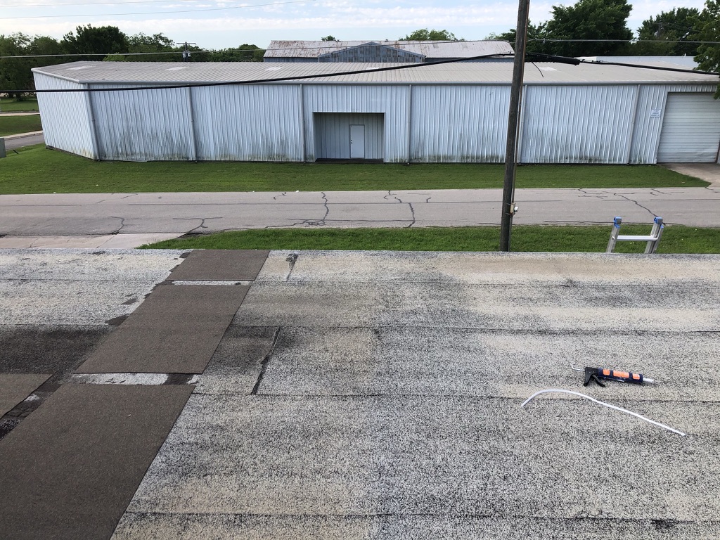 Damaged Modified Bitumen roof section allowing water intrusion at AT&T, 705 E Virginia St, McKinney, TX
