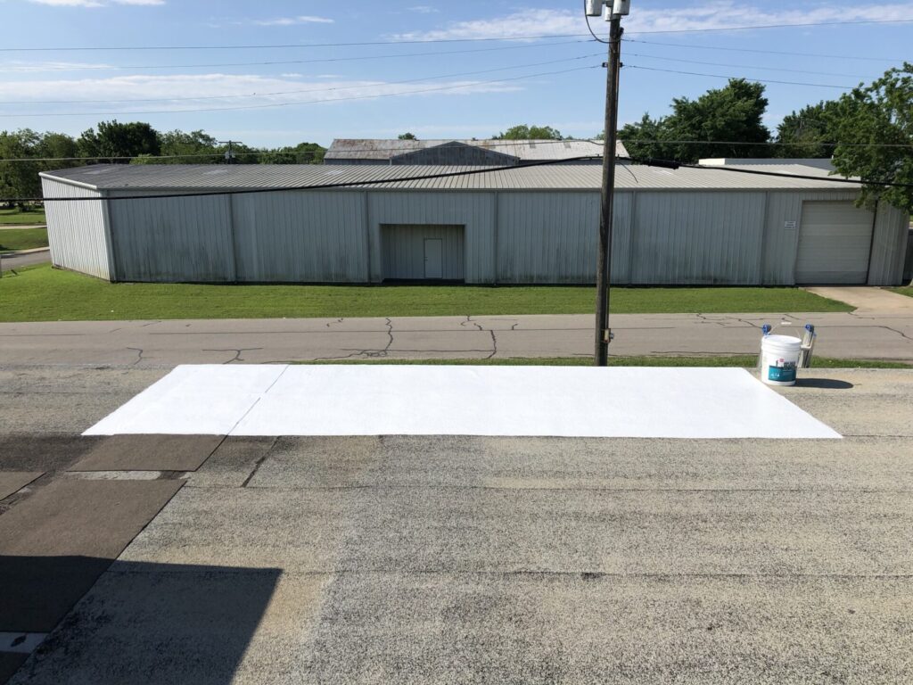 Failing seams and small holes identified in the Mod-Bit roof membrane in downtown McKinney, Texas