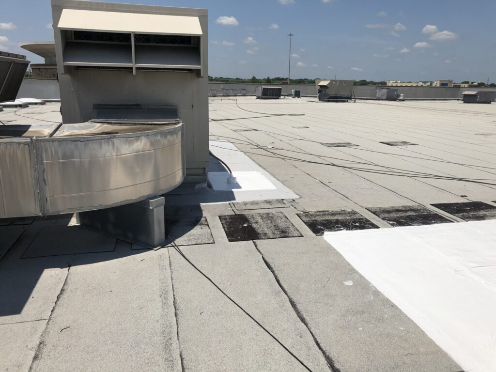 Silicone flood coat applied to seek out and fill voids on the LA Fitness commercial roof, McKinney, TX