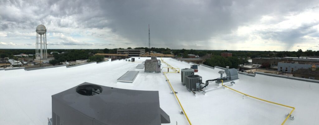 Completed silicone roof coating with sealed parapet coping cap seams in the McKinney historic district