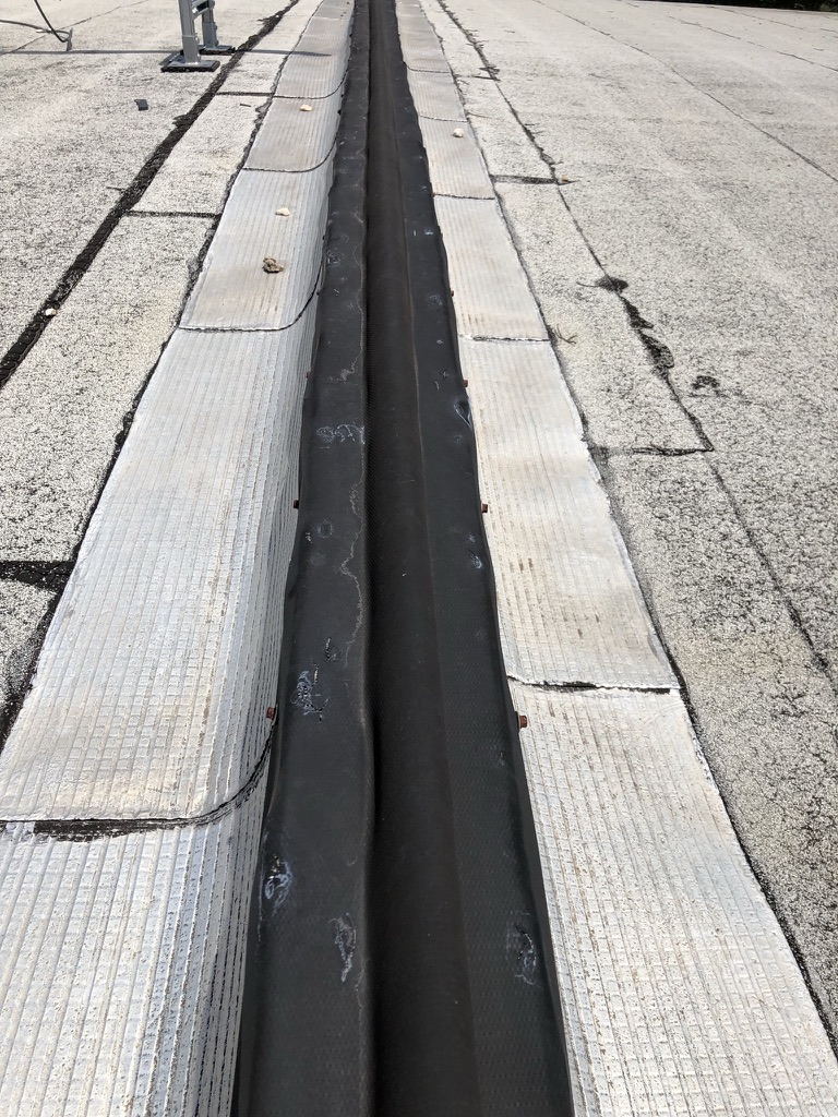 Silicone roof coating bulked with polypropylene and reinforced with nylon fabric over the expansion joint, Melissa, Texas