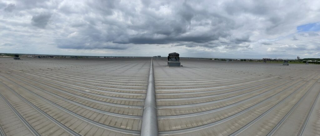 Panoramic view of a large-scale industrial metal roof in Midlothian, TX