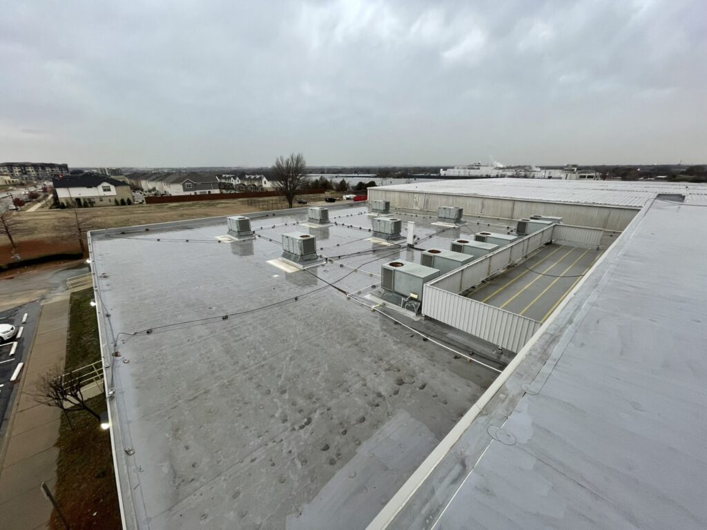 Completed silicone roof coating system on 45,000 sq ft TPO roof at Iron Horse Blvd, NRH