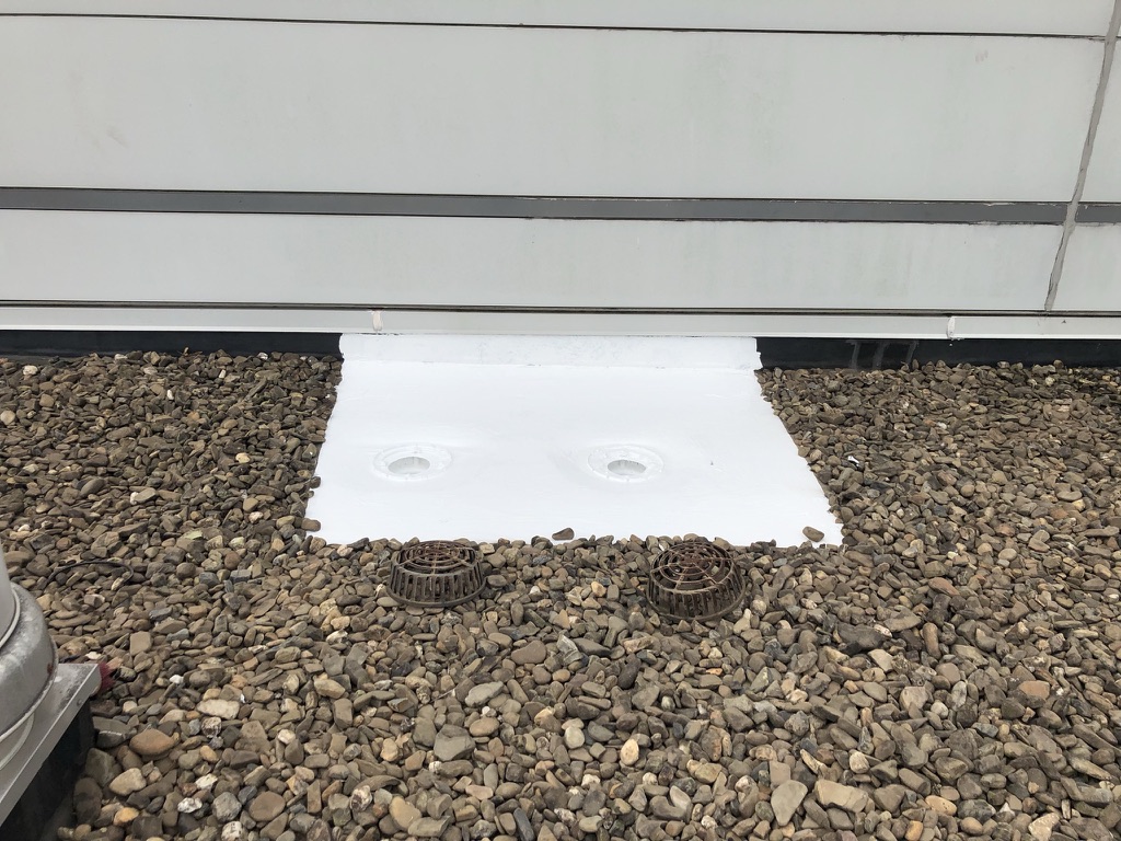 Silicone roof coating flooded out around the repaired drain cap on the ballasted EPDM roof, Paris, Texas