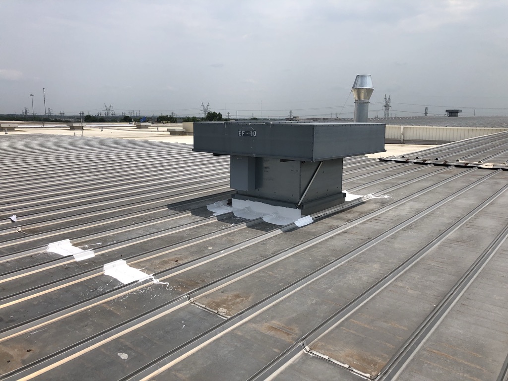 Completed silicone seam repair on the industrial standing seam roofing system in Paris, TX