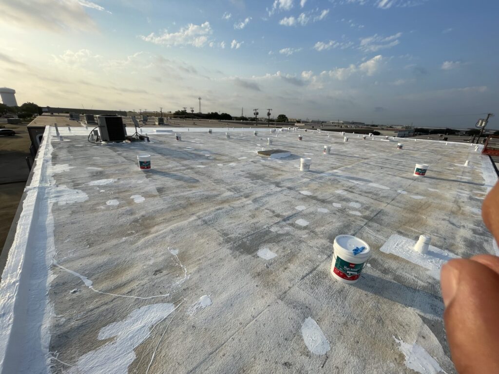 Silicone mastic applied to damaged foam and penetrations on the SPF roofing system, Plano, Texas