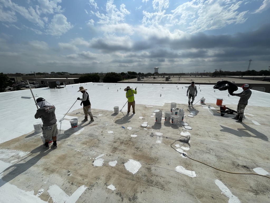 White silicone roof coating application over the SPF substrate at Bee Builders Supply, Plano
