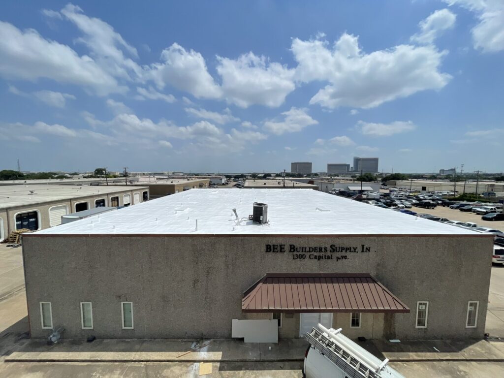 Completed white silicone roof coating on the commercial flat roof at 1300 Capital Ave., Plano, TX