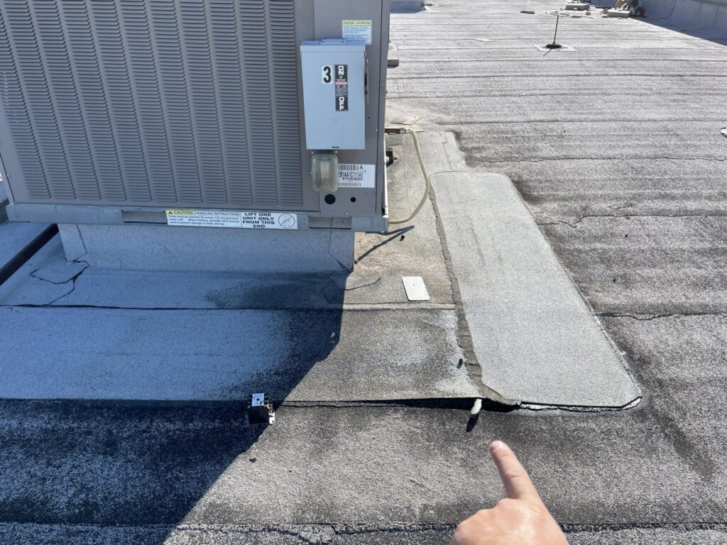 Old Modified Bitumen roof with failures around rooftop mechanical units at 6265 Coit Rd, Plano, TX
