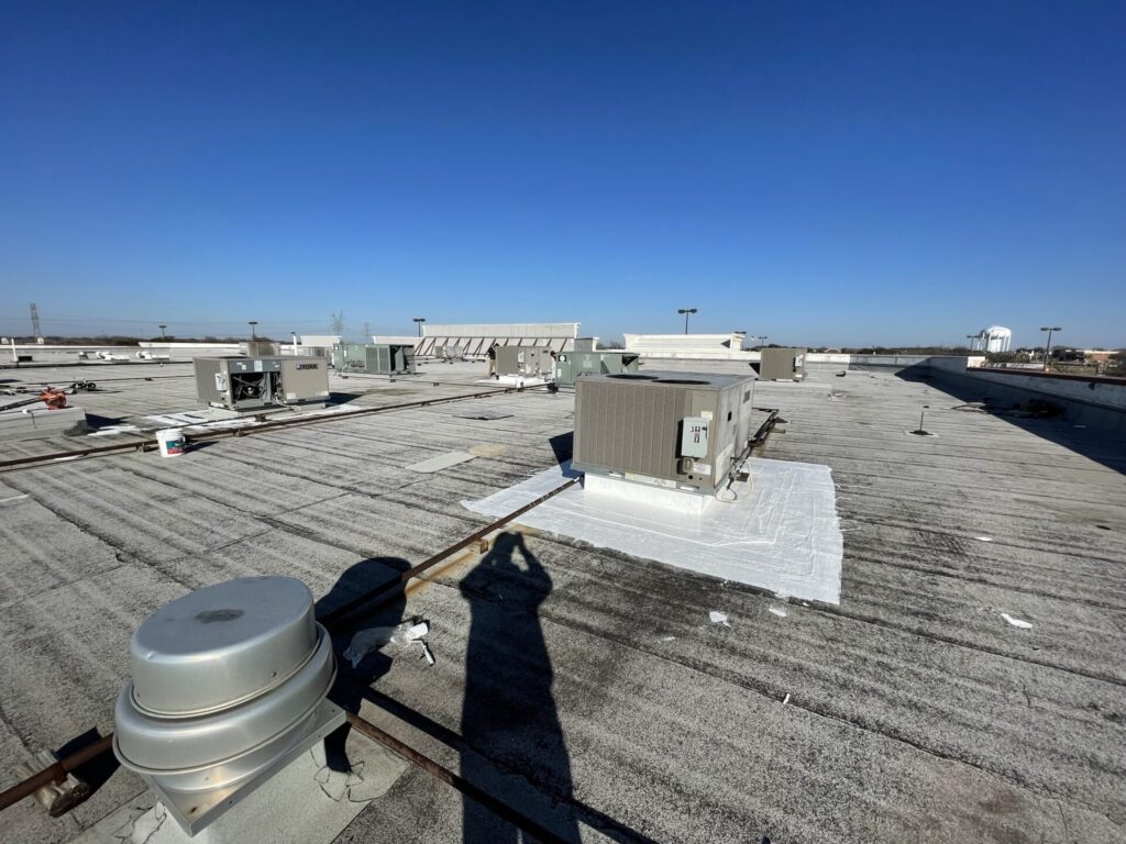 Silicone mastic applied to field seams and penetrations on the commercial roof at Coit Rd, Plano