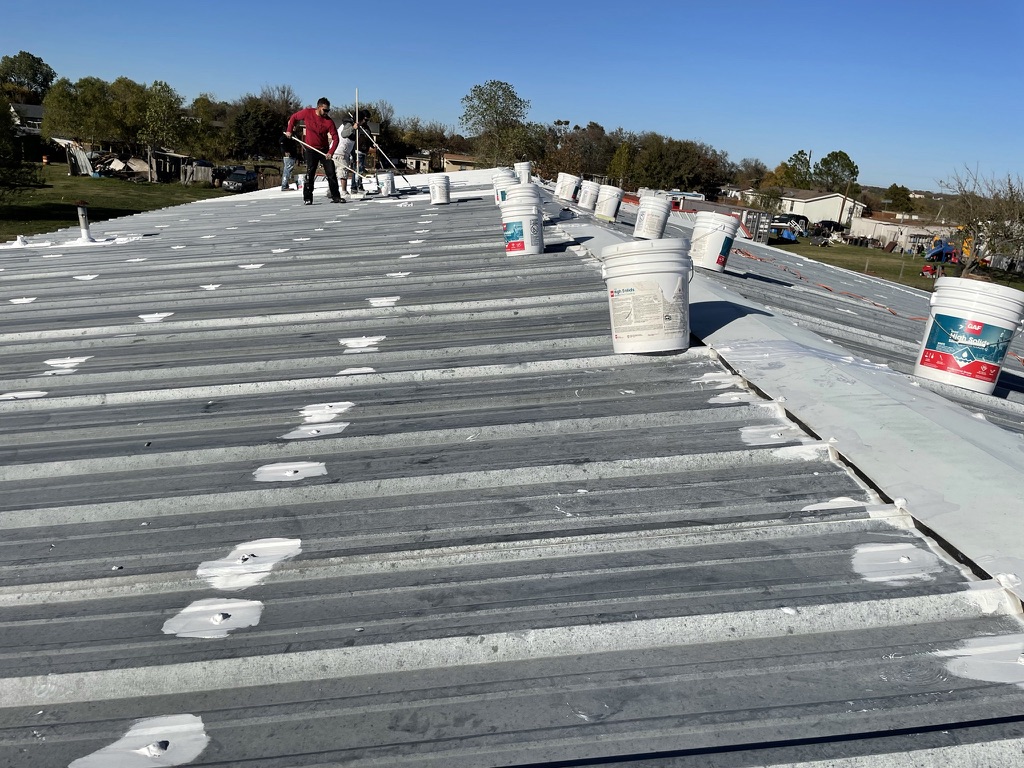 Silicone mastic applied at fastener heads and ridge vent on the fire station metal roof in Princeton, Texas