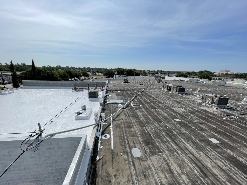 Silicone roof coating application over hail-damaged Mod-Bit roof at 165 W Jackson St, Richardson, TX
