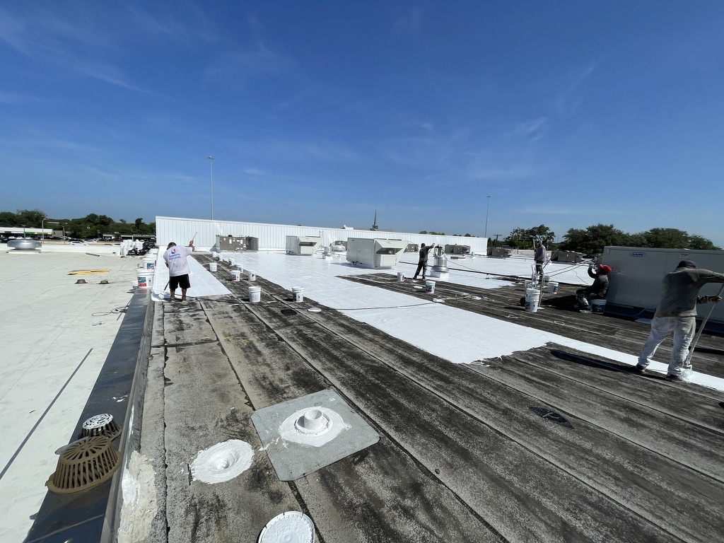 Detail work with silicone mastic on the commercial flat roof in the Richardson CORE District