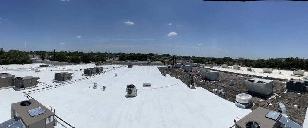 White silicone roof coating over the commercial flat roofing system at Clay Cooley Volkswagen, Richardson, Texas